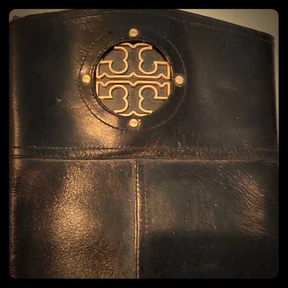 High to the knees black Tory Burch boots.